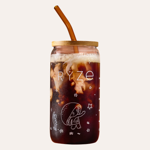 RYZE branded glass coffee can with bamboo lid and amber straw, filled with iced dark mushroom coffee