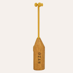 RYZE branded wooden mushroom frother: acorn-shaped wood handle with yellow silicone mixing head and RYZE logo engraved on...